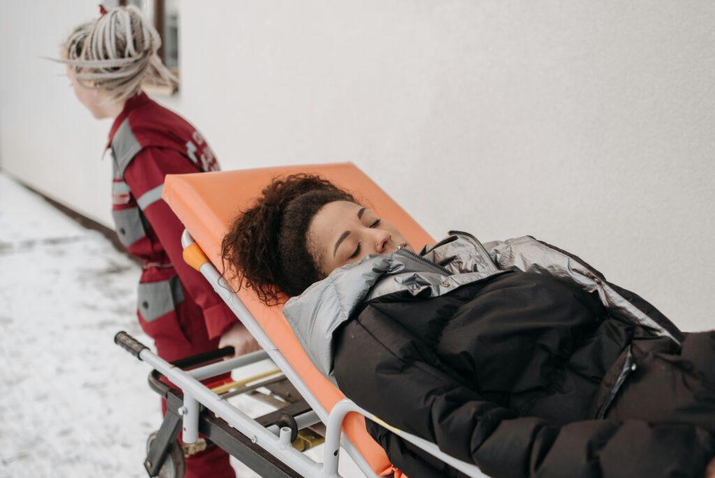 crush-injuries Medical personnel assisting a patient on a stretcher outdoors in a snowy setting. crush injuries rescue