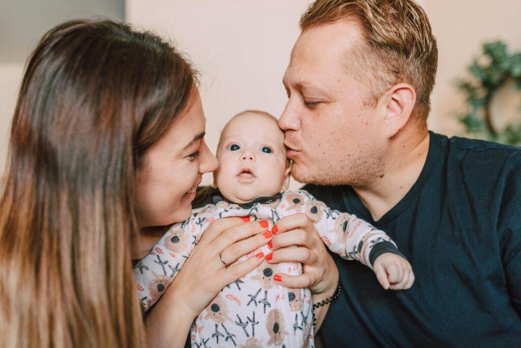 best-age-for-circumcision-surgery Loving parents gently playing with their happy baby boy after safe circumcision procedure, telling about The Best Age for Circumcision,